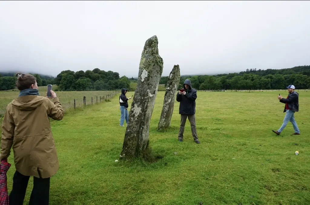 Students scanning Scottish stone